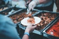 Volunteers serving food for poor people : concept of free food serving Royalty Free Stock Photo