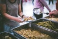 Volunteers serving food for poor people : concept of free food serving Royalty Free Stock Photo