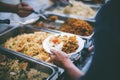 Volunteers serving food for poor people : concept of free food serving Royalty Free Stock Photo