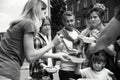 Volunteers serving food for poor people outdoors Royalty Free Stock Photo