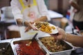 Volunteers serving food for poor people : Food sharing concept Royalty Free Stock Photo