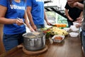 Volunteers serving food to  people in charity centre, closeup Royalty Free Stock Photo
