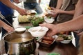 Volunteers serving food to poor  in charity centre Royalty Free Stock Photo