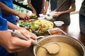 Volunteers serving food to poor people in charity centre Royalty Free Stock Photo