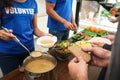 Volunteers serving food to poor people in charity centre Royalty Free Stock Photo