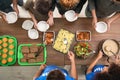 Volunteers serving food to poor people indoors Royalty Free Stock Photo