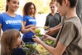 Volunteers serving food to poor people Royalty Free Stock Photo