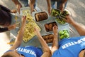 Volunteers serving food to poor people outdoors Royalty Free Stock Photo