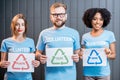 Volunteers with signs of sorting waste