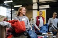 Volunteers sorting out donated clothes in community charity donation center. Royalty Free Stock Photo