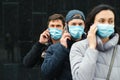 Volunteers wearing face masks with mobile phones outdoors. Volunteers are ready to help. Call to volunteers. The concept of mutual