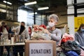 Volunteers working with food and clothes in community charity donations center, coronavirus concept. Royalty Free Stock Photo