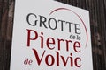 Volvic Grotte de la pierre sign and logo in city spring water fountain in French