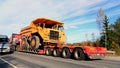 Volvo BM 540 Rigid Dump Truck on Truck Trailer as Wide Load Royalty Free Stock Photo