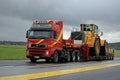 Volvo FH12 Hauls Wheel Loader on Rainy Day Royalty Free Stock Photo