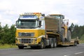 Volvo FH16 Semi Hauls CAT Wheel Loader Royalty Free Stock Photo