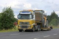 Volvo FH16 Semi Hauls Wheel Loader Through Rural Scenery Royalty Free Stock Photo