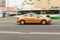 Volvo S60 T4 side view. Orange compact executive car second generation in motion