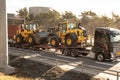 Volvo wheel loaders being transported on a trailer..