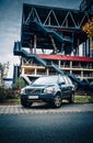 Volvo XC90 SUV stands on the street against the background of an abandoned industrial building with stairs and open areas on an au