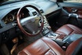 Volvo XC90 4.4 v8 1st generation restyling 4WD SUV premium car interior brown leather with forest view closeup from driver side