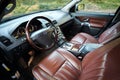 Volvo XC90 4.4 v8 1st generation restyling 4WD SUV premium car interior brown leather with forest view from driver side