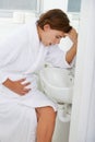 Vomiting, pregnant woman and morning sickness in bathroom, nausea and hand on stomach. Mirror reflection, moody and
