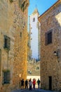 Tourists walk amazed among the medieval tall buildings in CÃÂ¡ceres, Extremadura, Spain.