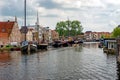 The Galgewater canal in Leiden, Netherlands, with old ships and houseboats. Royalty Free Stock Photo