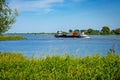 An inland vessel with containers on the River Waal.