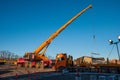 Crane getting ready to lift steal beams onto a truck