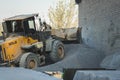 Voronezh region, Russia, april, 25 2019. Tractor loads crushed stone in the production of concrete. Yellow tractor loader running