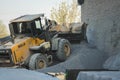 Voronezh region, Russia, april, 25 2019. Tractor loads crushed stone in the production of concrete. Yellow tractor loader running