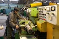 Voronezh, Russia - Circa 2010: Turner works on lathe machine in workshop