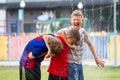 Voronezh, Russia: June 17, 2013. Boys under the water jets in the park on a hot sunny day. Joy, fun Royalty Free Stock Photo