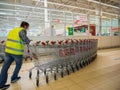 A worker collects empty carts at the Auchan supermarket, Voronezh