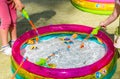 Children catch toy fish in the children`s pool.