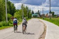 VORSINO, RUSSIA - JULY 2017: Working guest workers riding a bicycle to the village