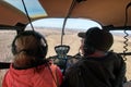 Voskresensk, Russia - May 1, 2019: Men and woman, two people are flying in the cockpit of the Robinson R44 helicopter