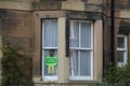 Vote Green and SNP Posters on a House Window