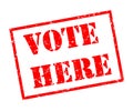 Vote here stamp on white background Royalty Free Stock Photo