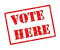 Vote here stamp on white background Royalty Free Stock Photo