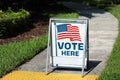 Vote Here Sign on election day Royalty Free Stock Photo