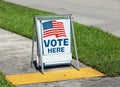 Vote Here Sign on election day Royalty Free Stock Photo