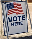 Vote Here sign in a parking lot