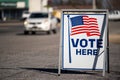 Vote Here sign in a parking lot