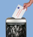 Absentee ballot of vote by mail envelope being shredded in an office shredder Royalty Free Stock Photo