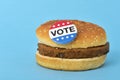 Vote pin button on a hamburger Royalty Free Stock Photo