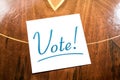 Vote Reminder On Paper Lying On Wooden Cupboard