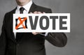 Vote sign is held by businessman Royalty Free Stock Photo